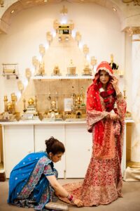 Portrait of a Pakistani bride in red saree at her Mehndi