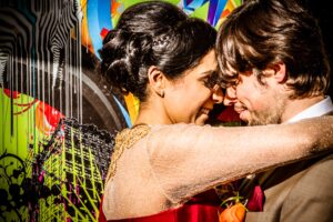 Modern English-Indian couple hugging each other after their wedding